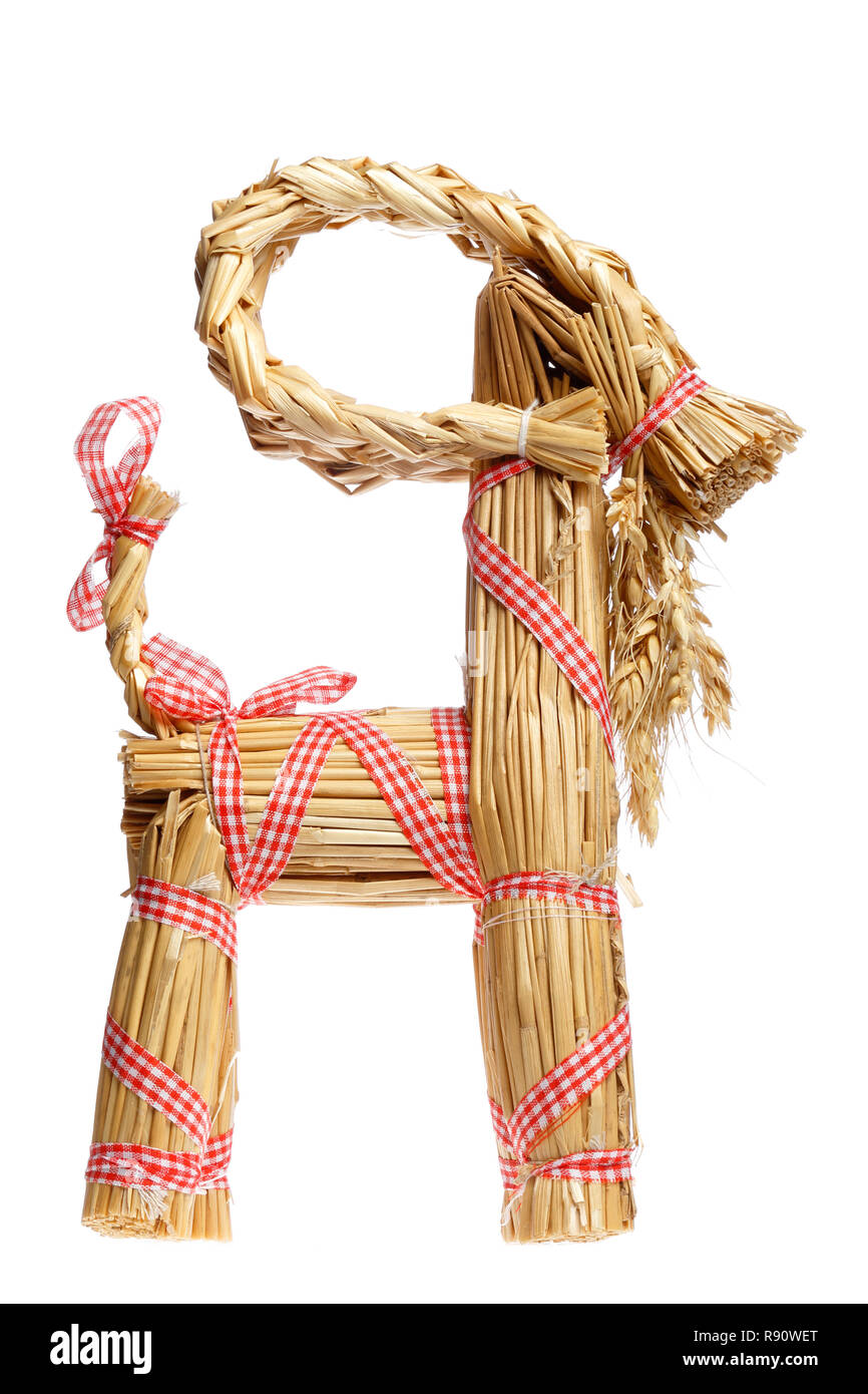 Side view of a traditional straw billy goat christmas decoration isolated on white. Stock Photo