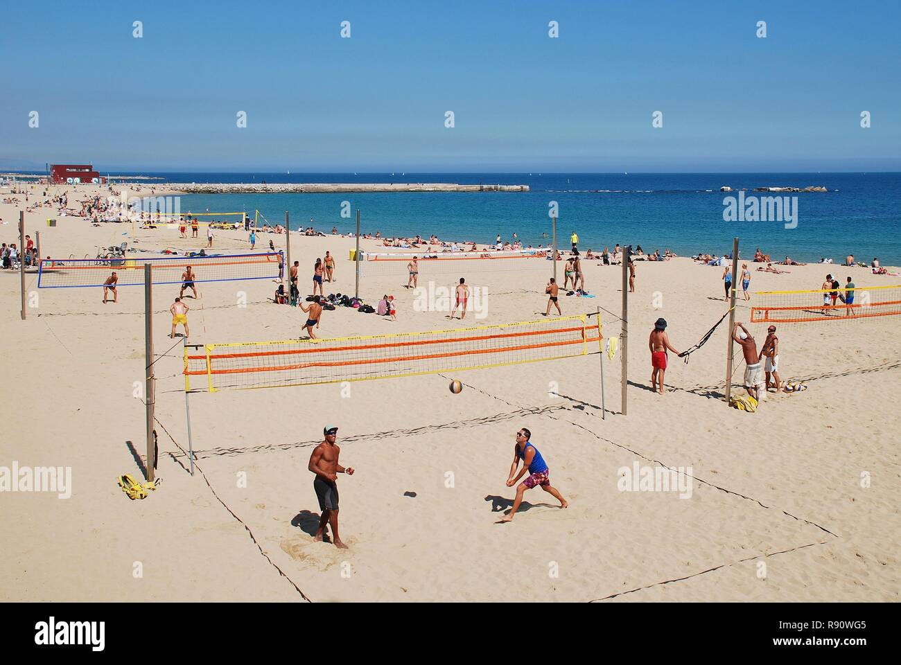 People play volley ball on the beach at Barcelona in Catalonia, Spain on April 17, 2018. Stock Photo