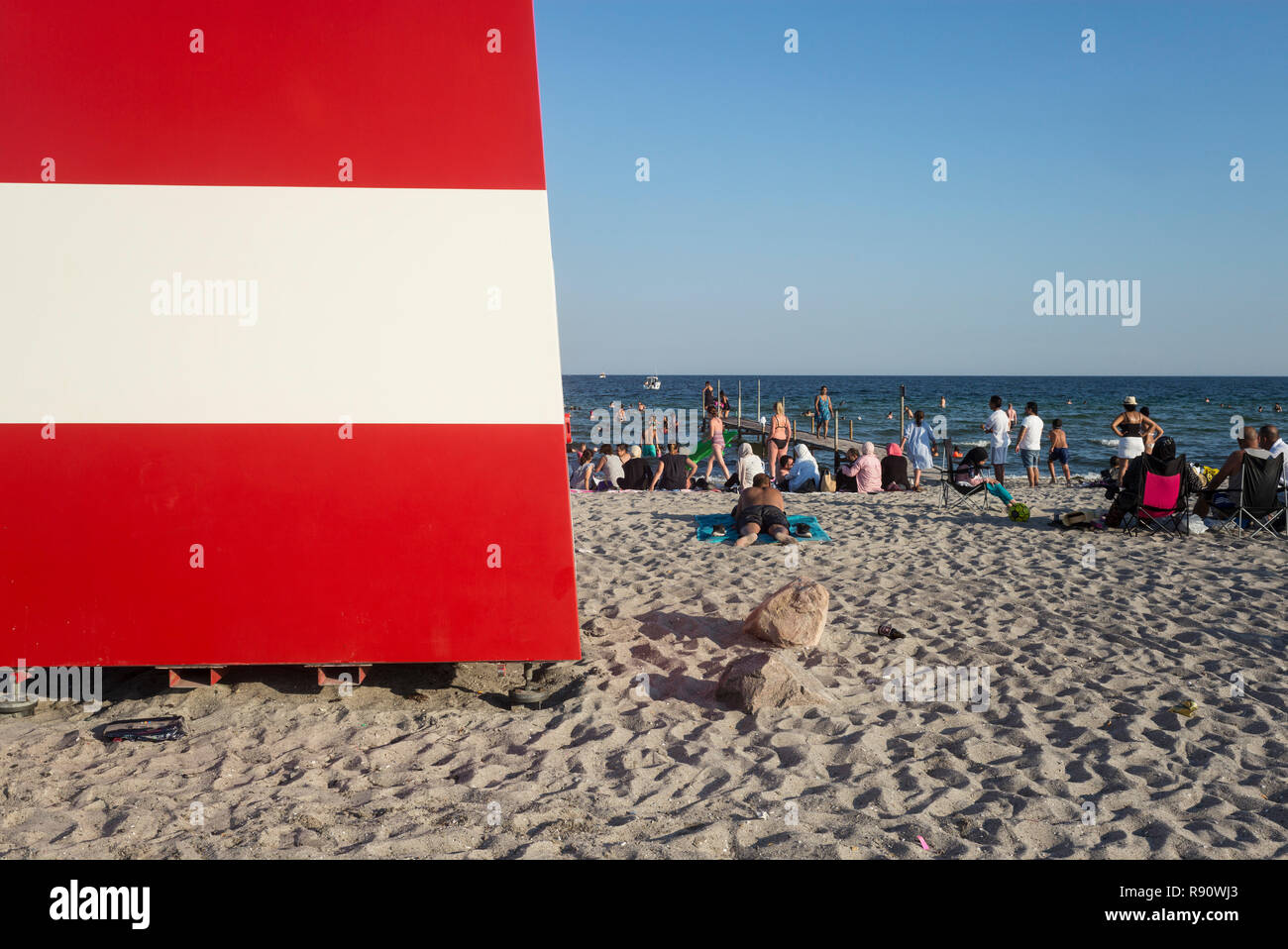 Copenhagen. Denmark. Red and white lifeguard cabin on Ishøj Strand beach overlooking Køge bay. Stock Photo