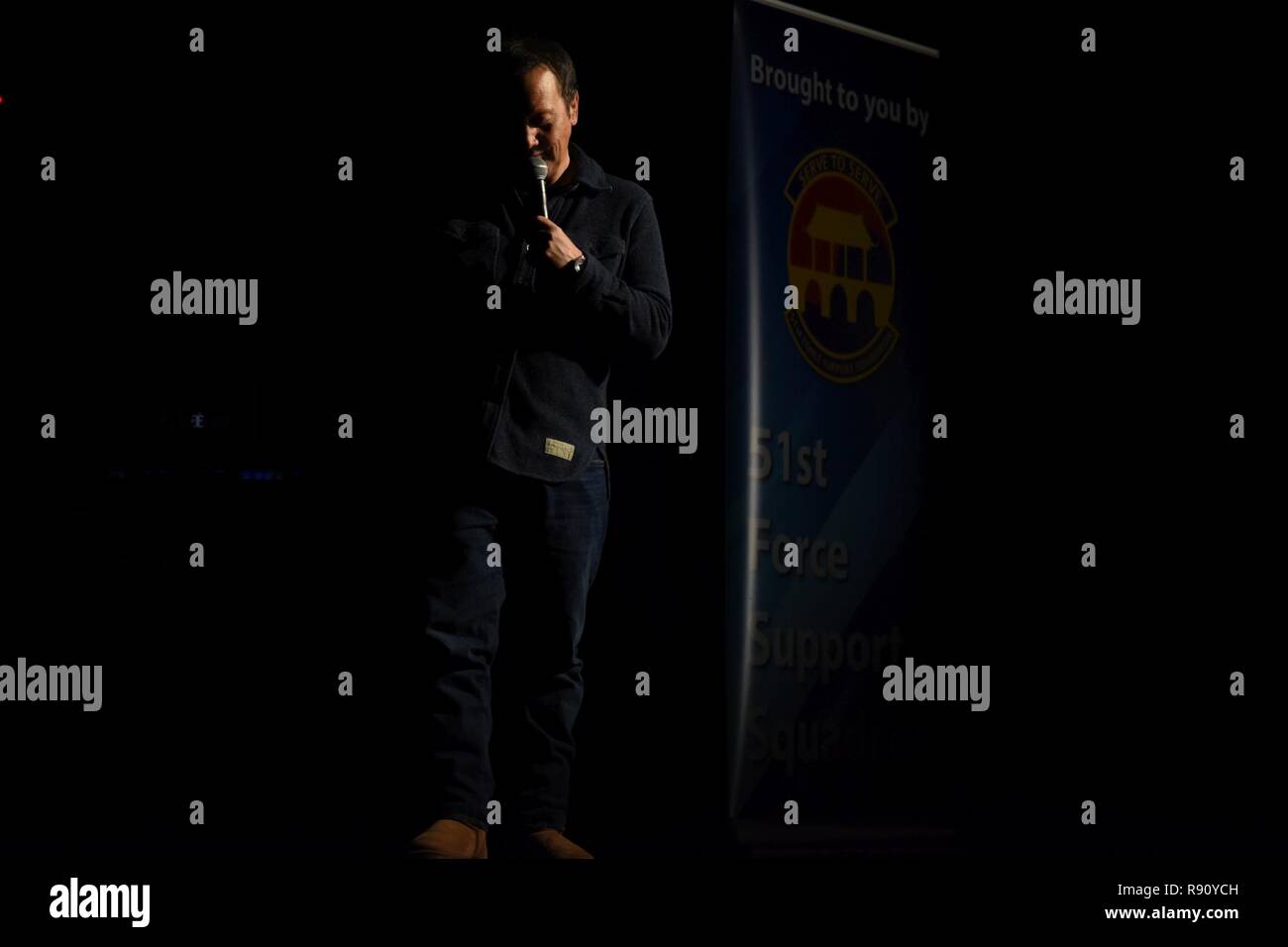 Rob Schneider, comedian and actor, performs stand-up comedy in the Enlisted Club at Osan Air Base, Republic of Korea, Dec. 9, 2018. Schneider is known for his roles in movies such as The Hot Chick, The Animal, 50 First Dates, The Waterboy and his most recent Netflix show, Real Rob. Stock Photo
