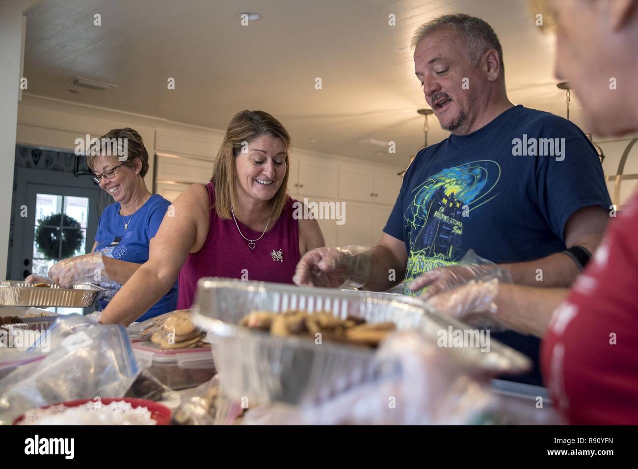 Members of the Tyndall Spouses Club bundle cookies into tin pans Dec. 9, 2018, in Panama City, Fla. The spouses club collected more than 300 dozen cookies that will be disseminated to Airmen throughout Tyndall as part of this 2018’s cookie caper. Stock Photo