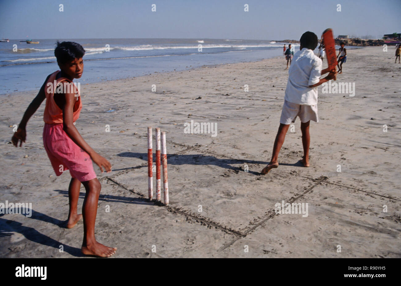 boys playing cricket on beach, India Stock Photo
