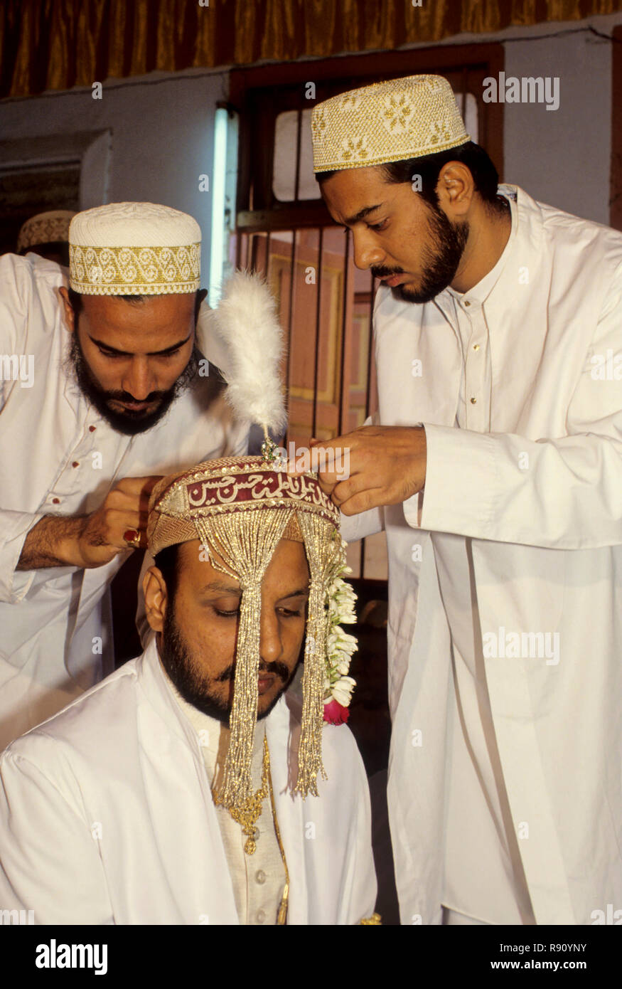 dressing up Bohra muslim bridegroom tying sehara, india Stock Photo