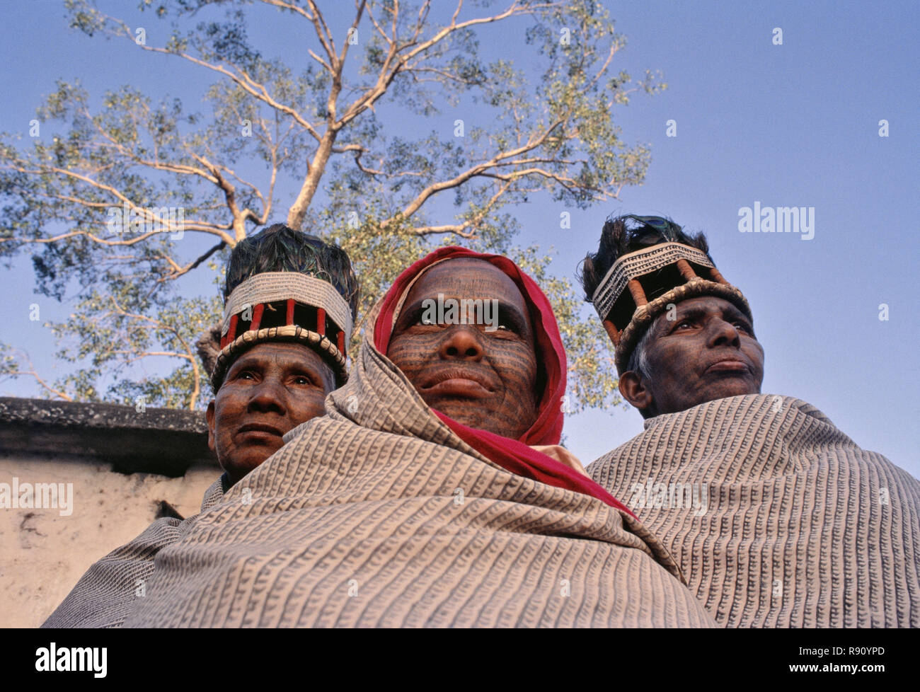 Bhaktains, women Ramnaami ascetics, with their tattooed bodies wearing striking black & white robes and peacock-feathered head gears, Central India. Stock Photo