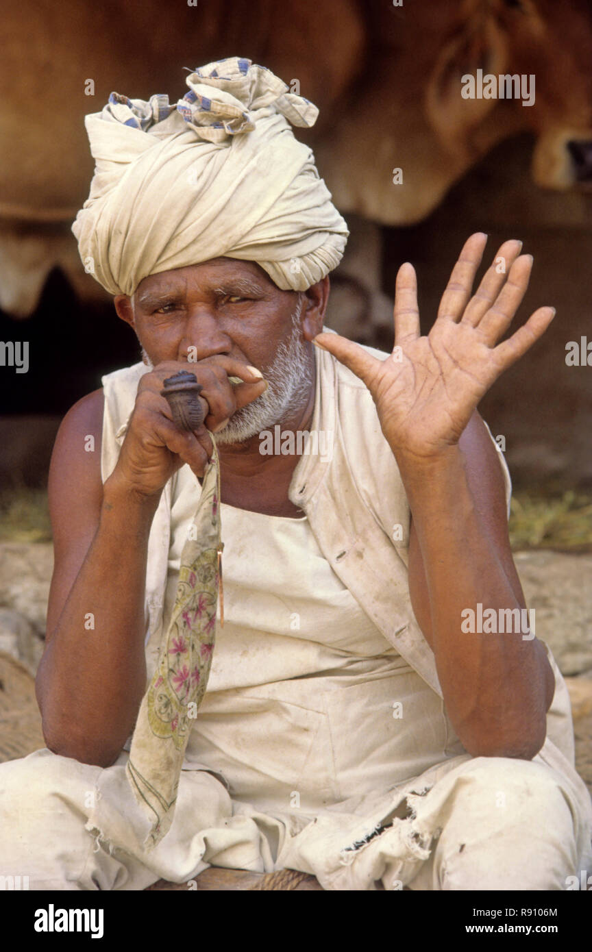 six finger family photo feature, old man showing hand palm and smoking  Stock Photo - Alamy