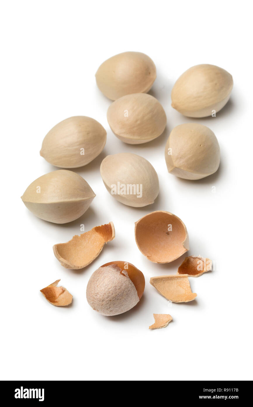 Fresh raw ginkgo biloba nuts and a shelled one isolated on white