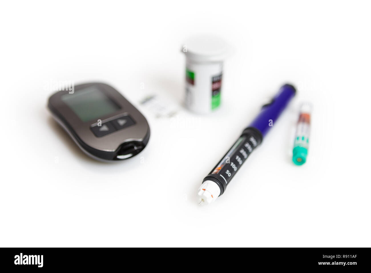 Diabetic mini set of glucometer, strips, box of spare strips and pen injector with spare insulin isolated on white background Stock Photo