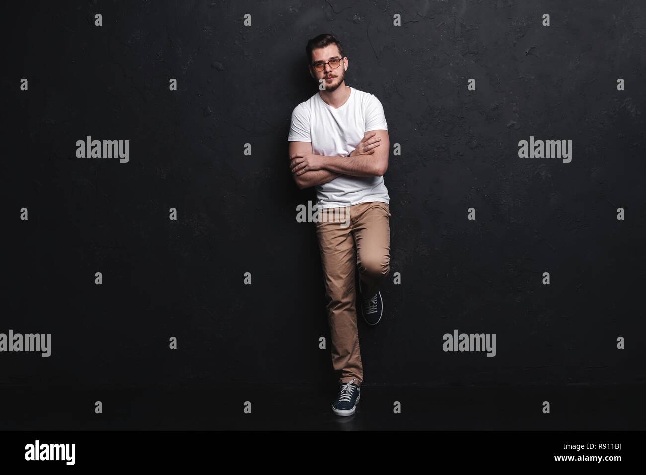 Full length portrait of happy handsome young man isolated on black ...