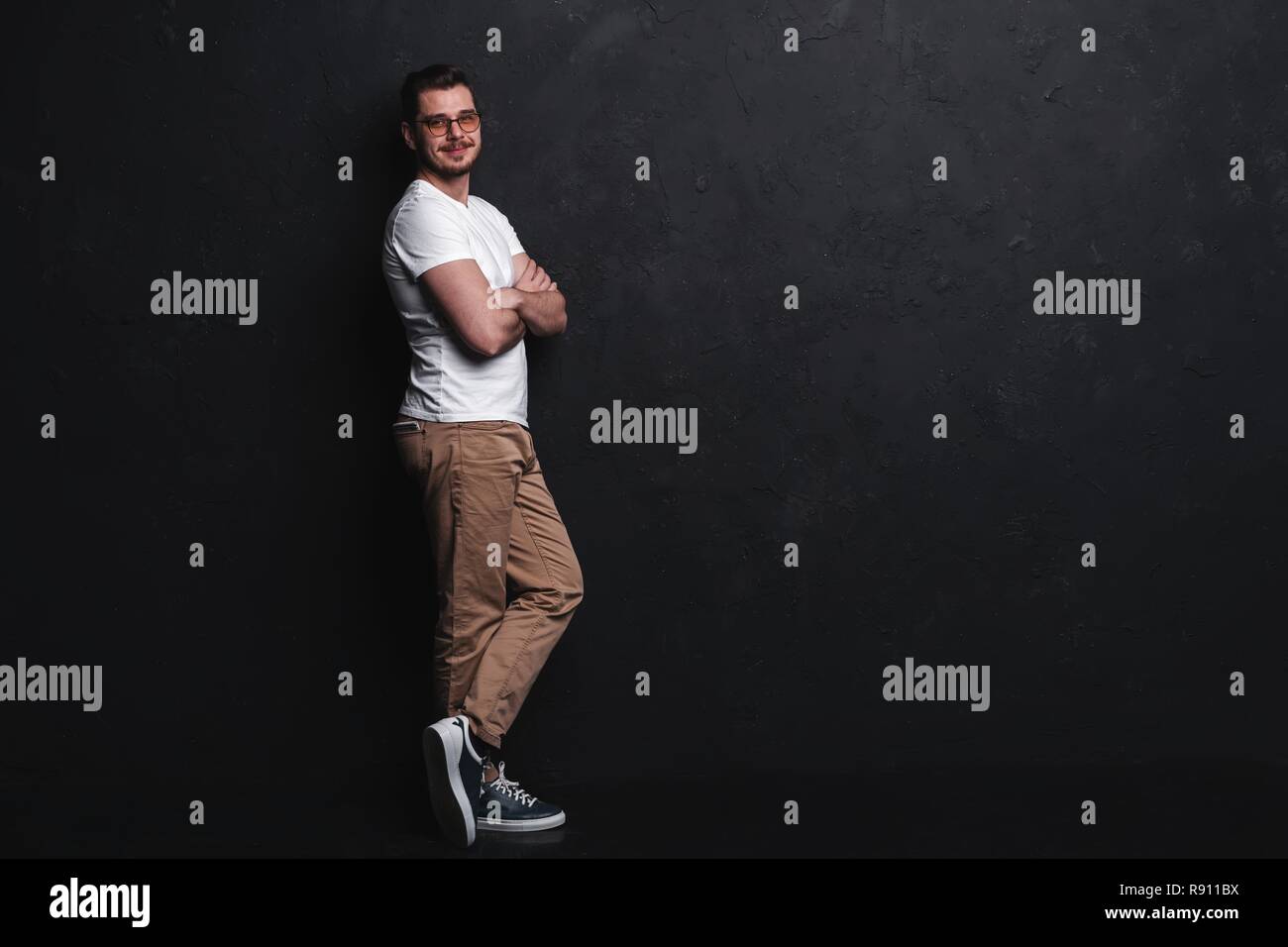 Full length portrait of happy handsome young man isolated on black ...