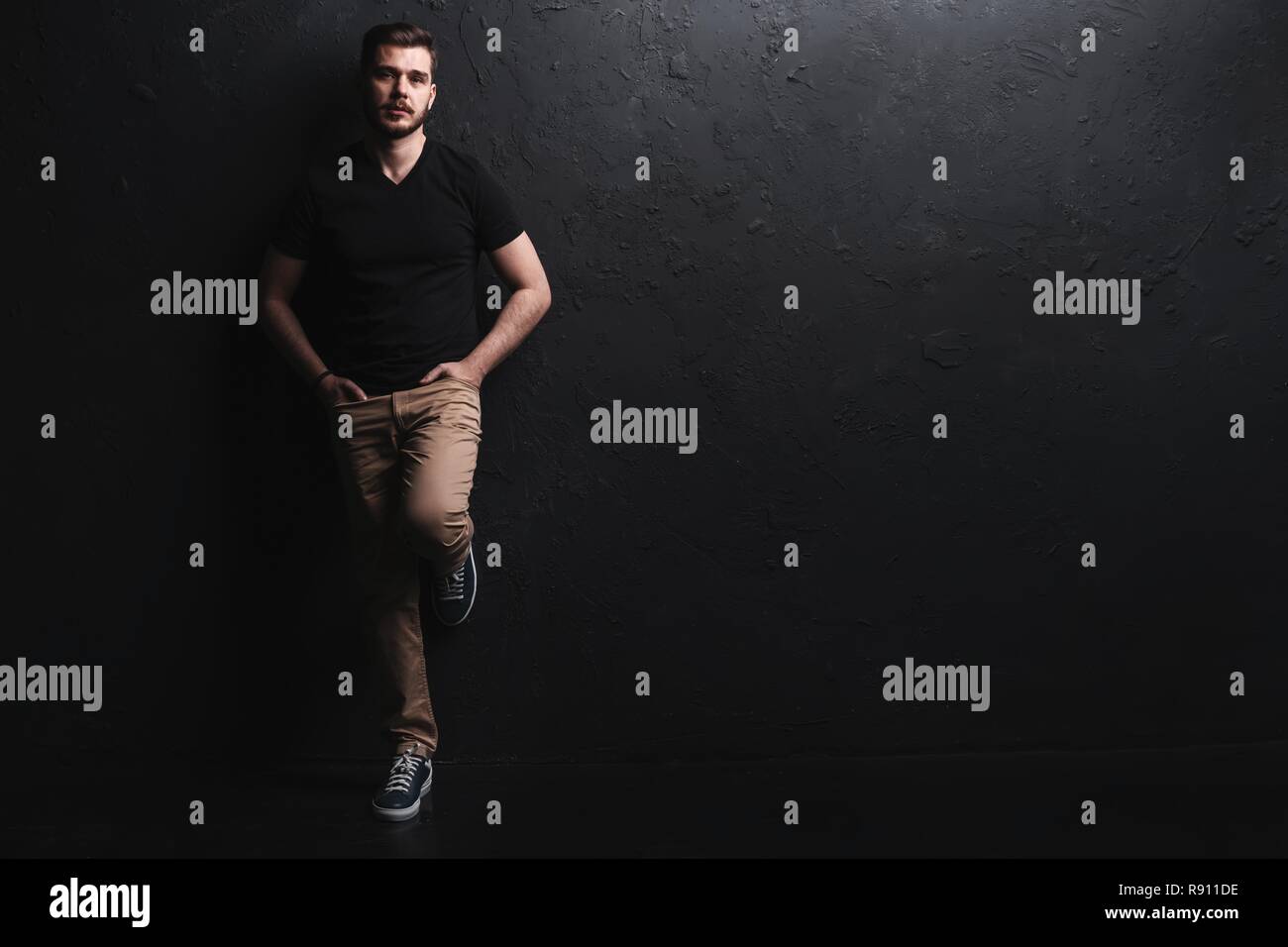 Full length portrait of happy handsome young man isolated on black ...