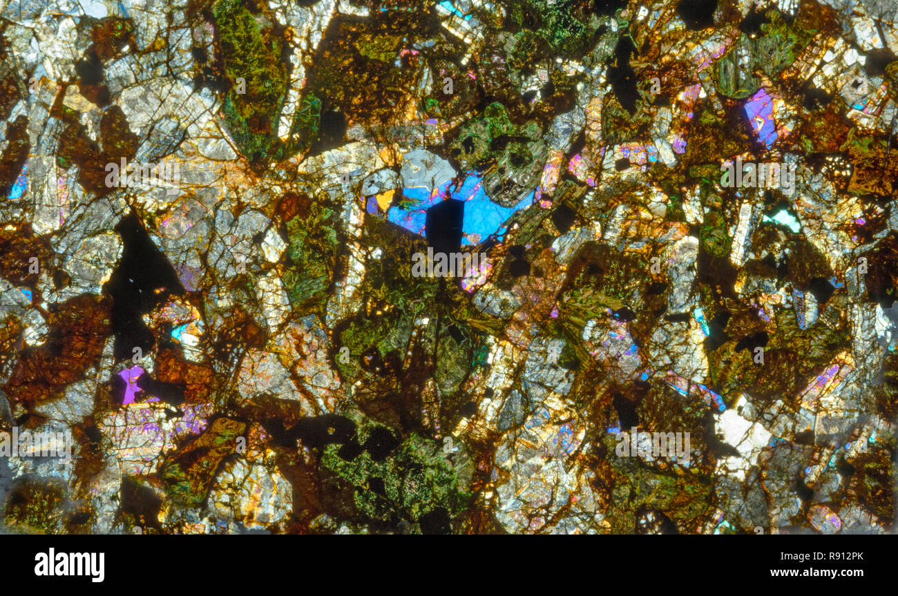 Altered Gabbro thin section cross polarized photomicrograph, contact metamorphism with granophyre. Carrock fell, Cumbria, UK Stock Photo