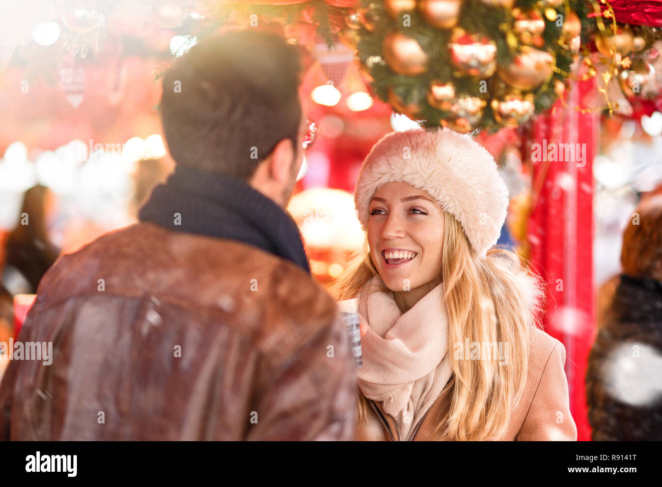 Christmastime. A couple walks in the decorated streets Stock Photo