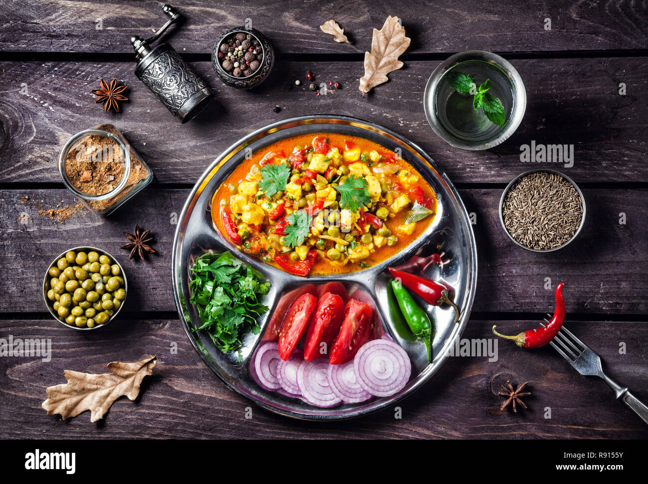 Indian Mutter paneer dish with spices on the wooden background Stock Photo