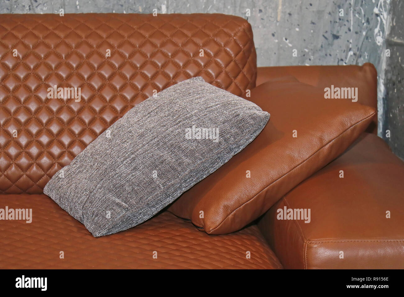 Brown leather couch corner with decorative pillows Stock Photo Alamy