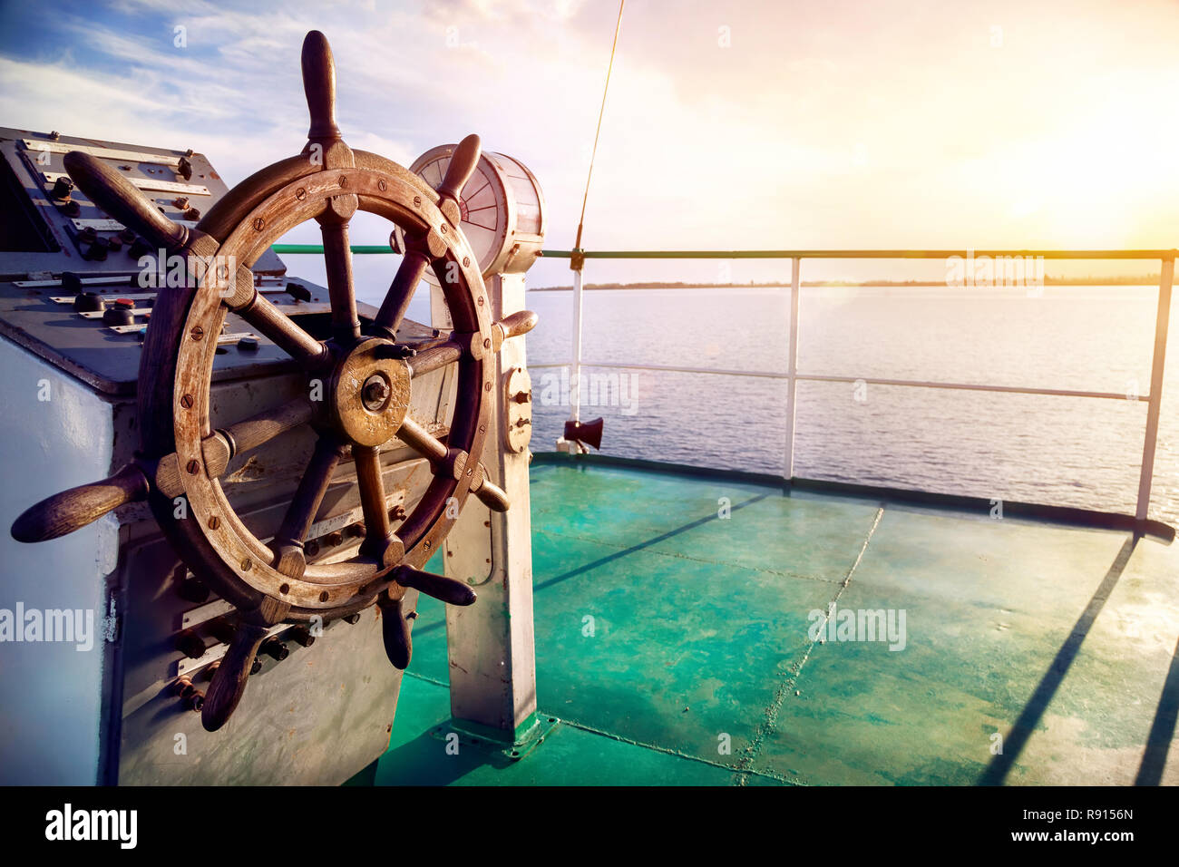 Wooden wheel on the ship at sunset on Issyk Kul lake Stock Photo