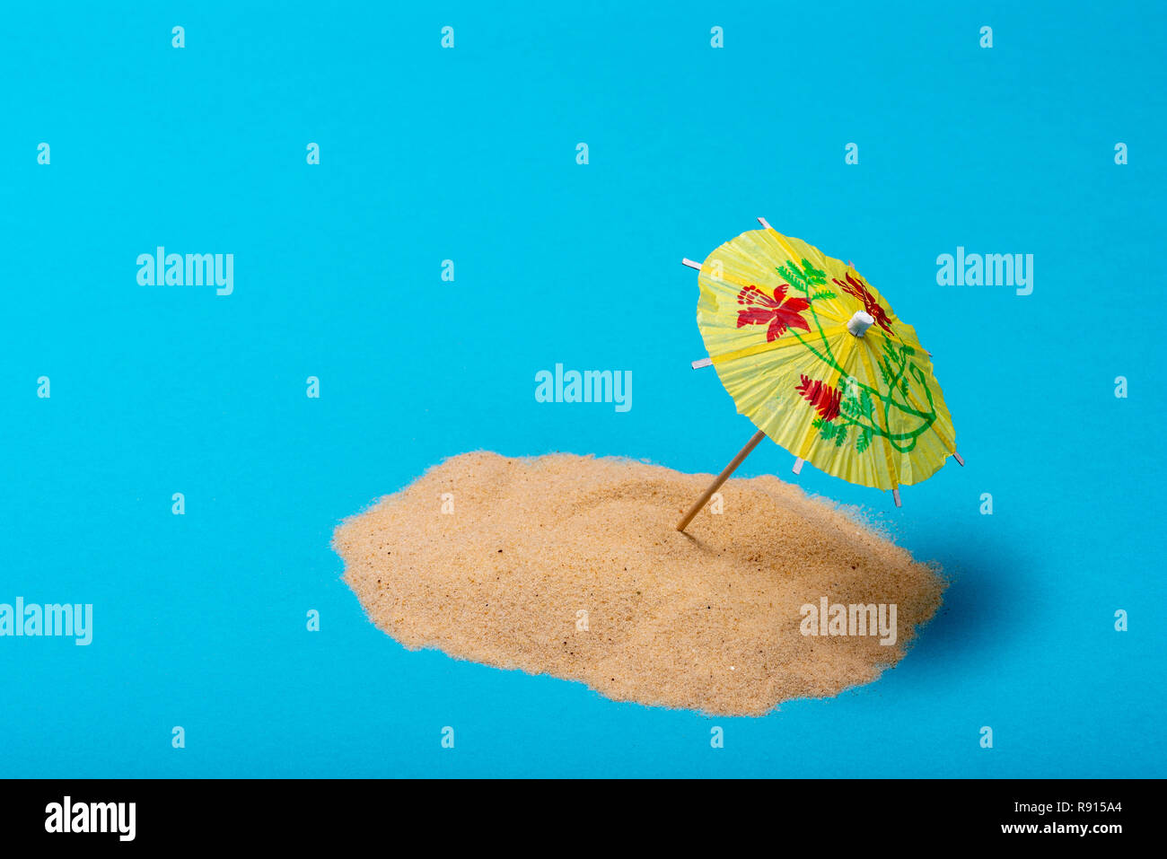 Concept of a remote tropical island paradise, with a beach parasol or umbrella. Stock Photo