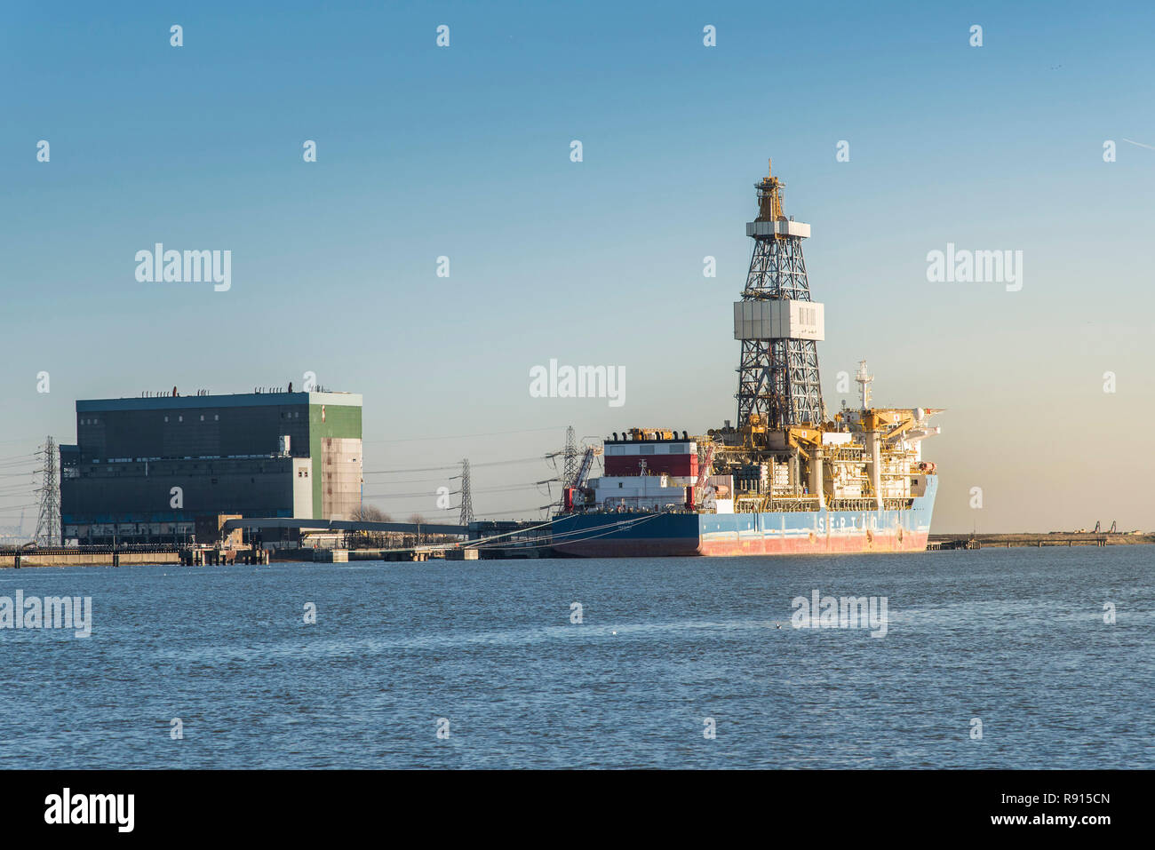 Shipping on the Thames.  Sertao a drilling ship used for exploratory offshore drilling moored at Tilbury Power Station on the River Thames. Stock Photo