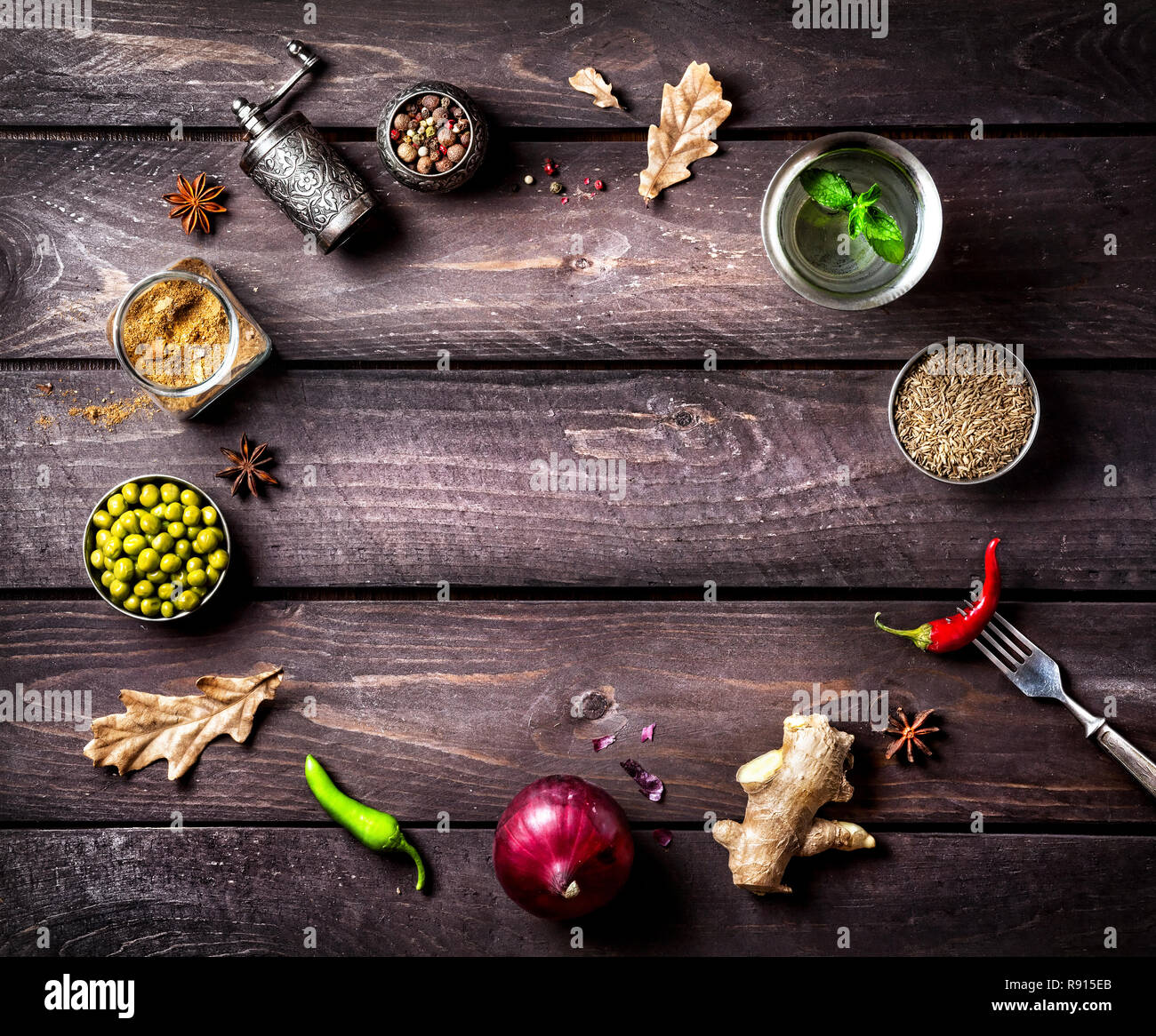 Spices and ingredients for the dish on the wooden background with space for text Stock Photo
