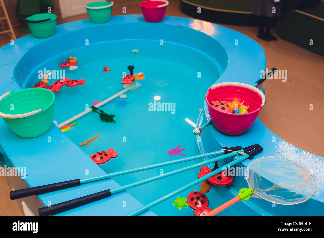 fishing in the paddling pool. Children's toys in the pool. Toy fish fishing  rod. Cheerful children fishing, fishing in the paddling pool Stock Photo -  Alamy