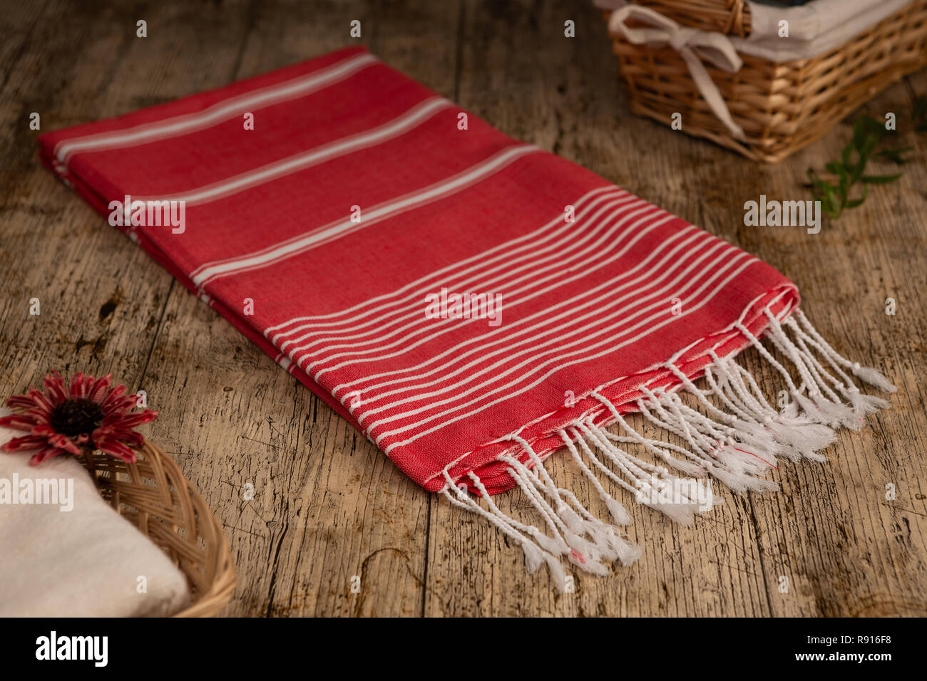 Handwoven hammam Turkish cotton towel on wooden background Stock Photo