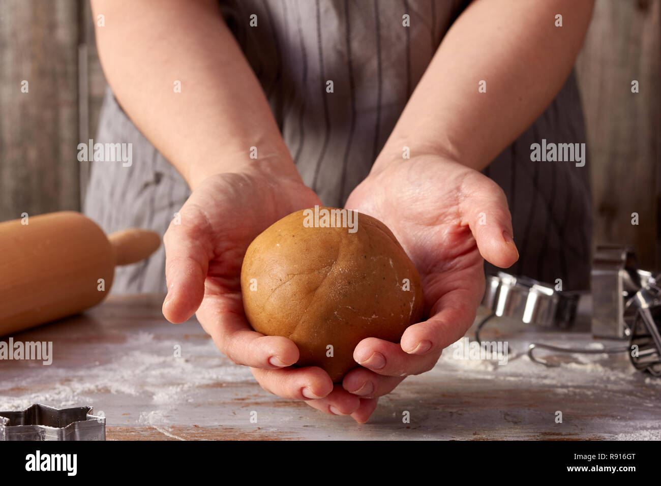 Ball of gingerbread dough in woman hands Stock Photo