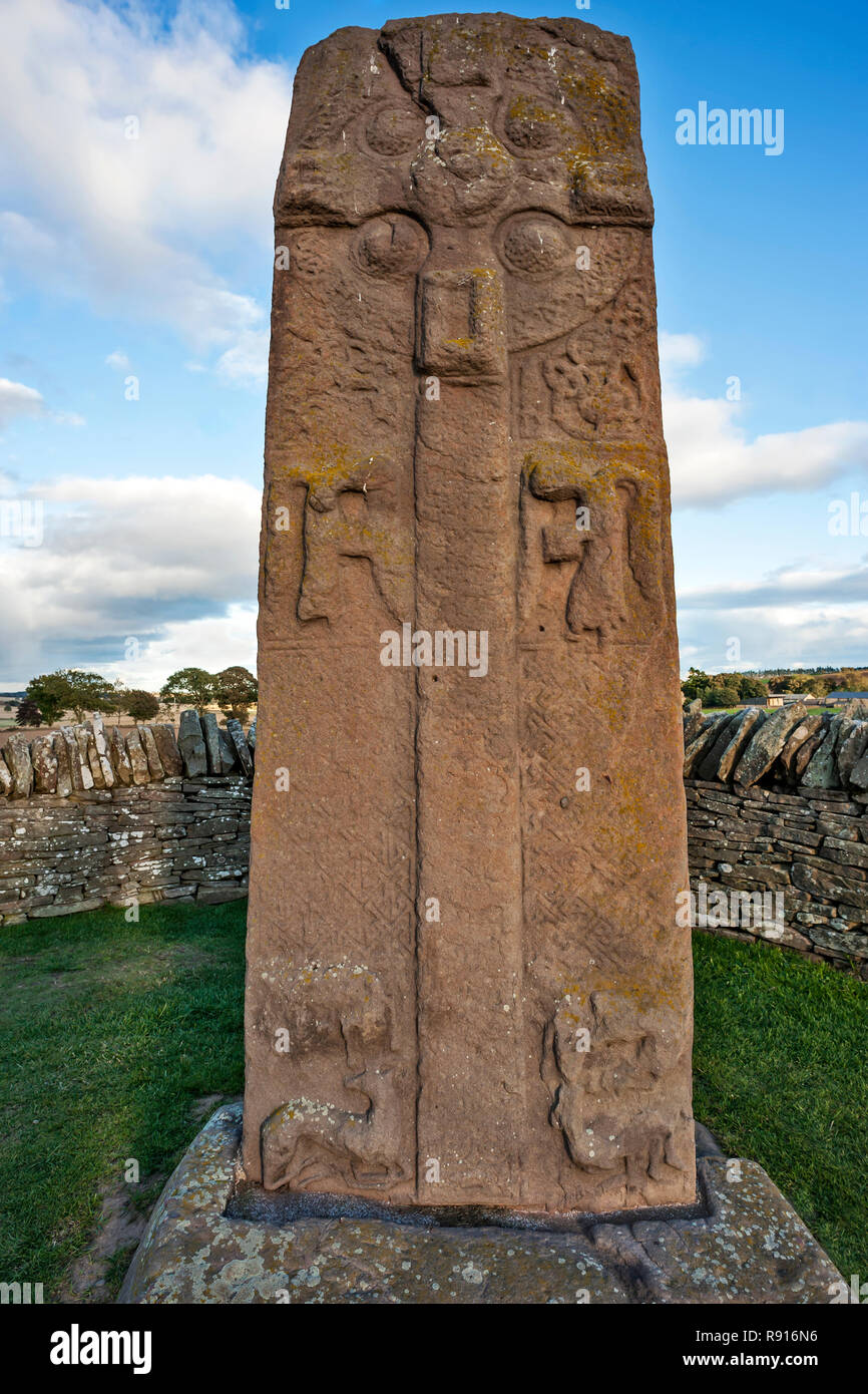 Early Medieval Standing Stone, The Roadside Cross,  by roadside at Aberlemno, Angus Scotland UK against a bright blue cloudy sky Stock Photo