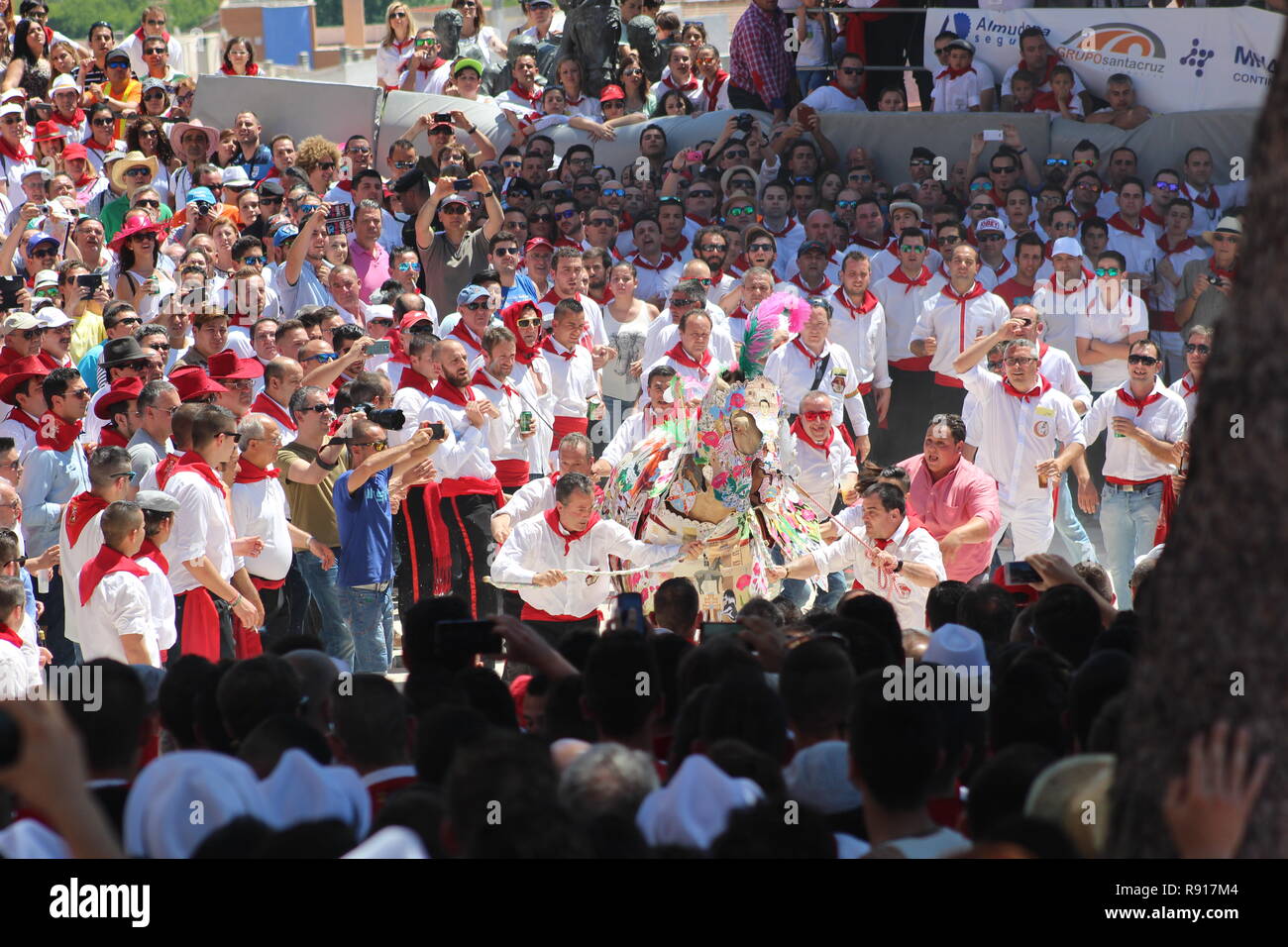 Horses and men competing in the Los Caballos Del Vino in Caravaca de la Cruz.  Embroidery is used to make the horse's costume. Stock Photo