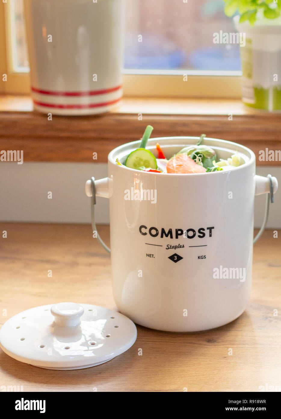 sustainable living kitchen waste recycling, kitchen waste compost pot  containing kitchen waste on kitchen counter top Stock Photo - Alamy