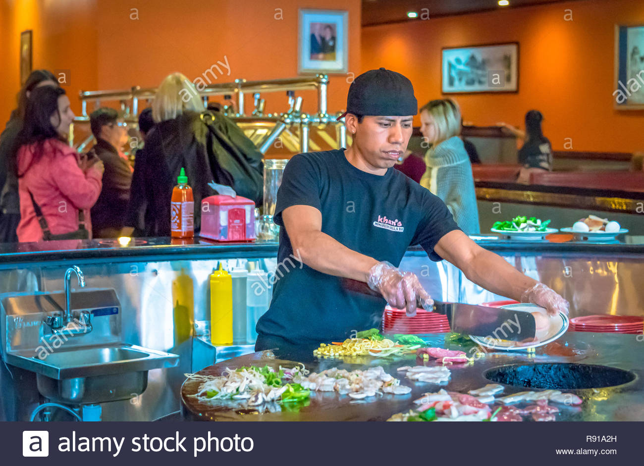 Mongolian Buffet Restaurant Kitchen Scenes In New York City Man Cutting Vegetables On A Large Circular Hot Pan At A Restaurant In Nyc Stock Photo Alamy