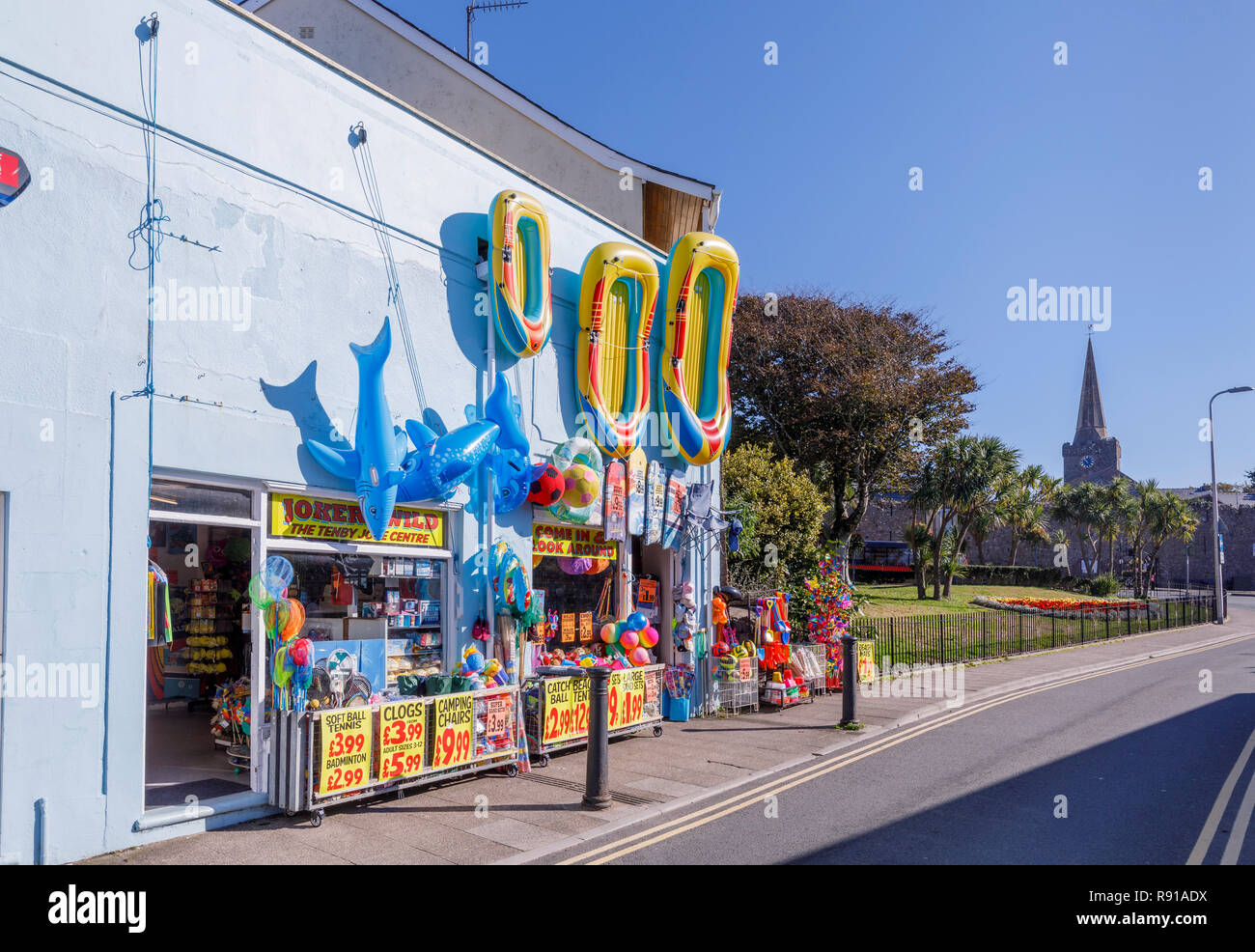 Display of colourful blow-up beach toys in a shop in Tenby, a walled seaside town in Pembrokeshire, south Wales coast on the west of Carmarthen Bay Stock Photo