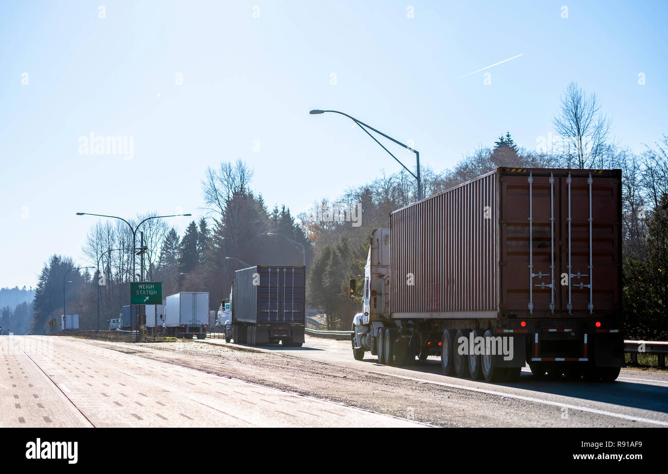 Different big rigs semi trucks with containers and semi trailers ...