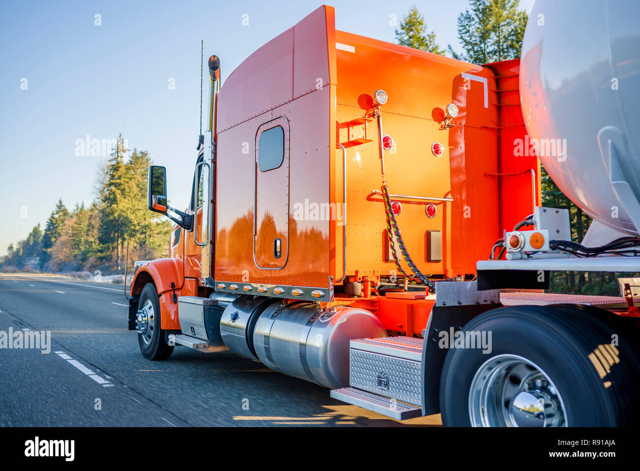 Bright orange big rig American professional long haul semi truck