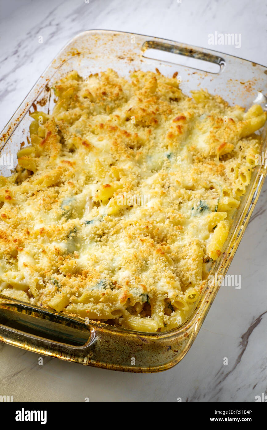Creamy baked chicken alfredo with penne pasta topped with parmesan and