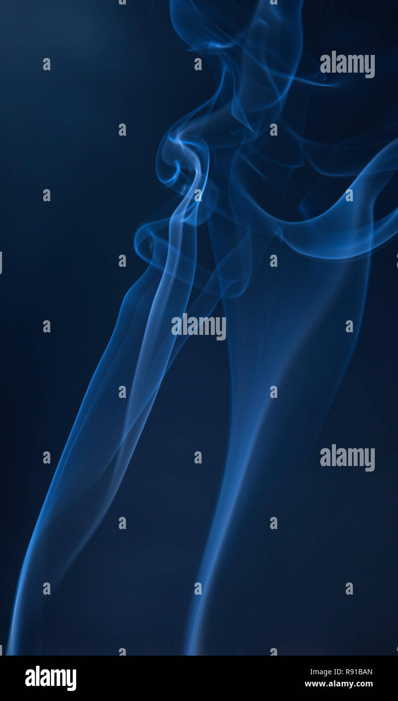 Abstract blue smoke swirls on dark background Stock Photo - Alamy