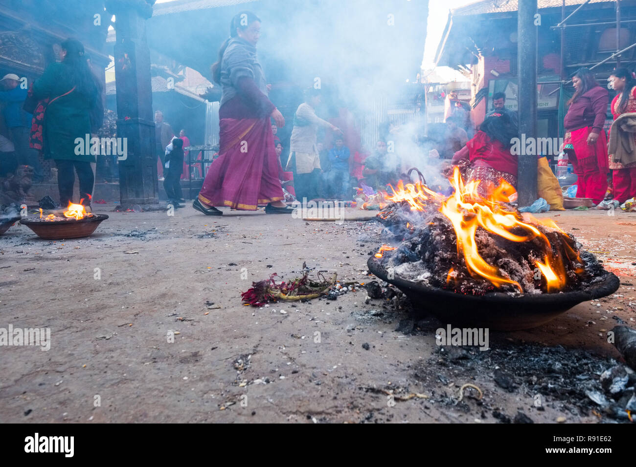 Smoke and flames of offerings at a Hindu temple in Patan, Nepal Stock Photo