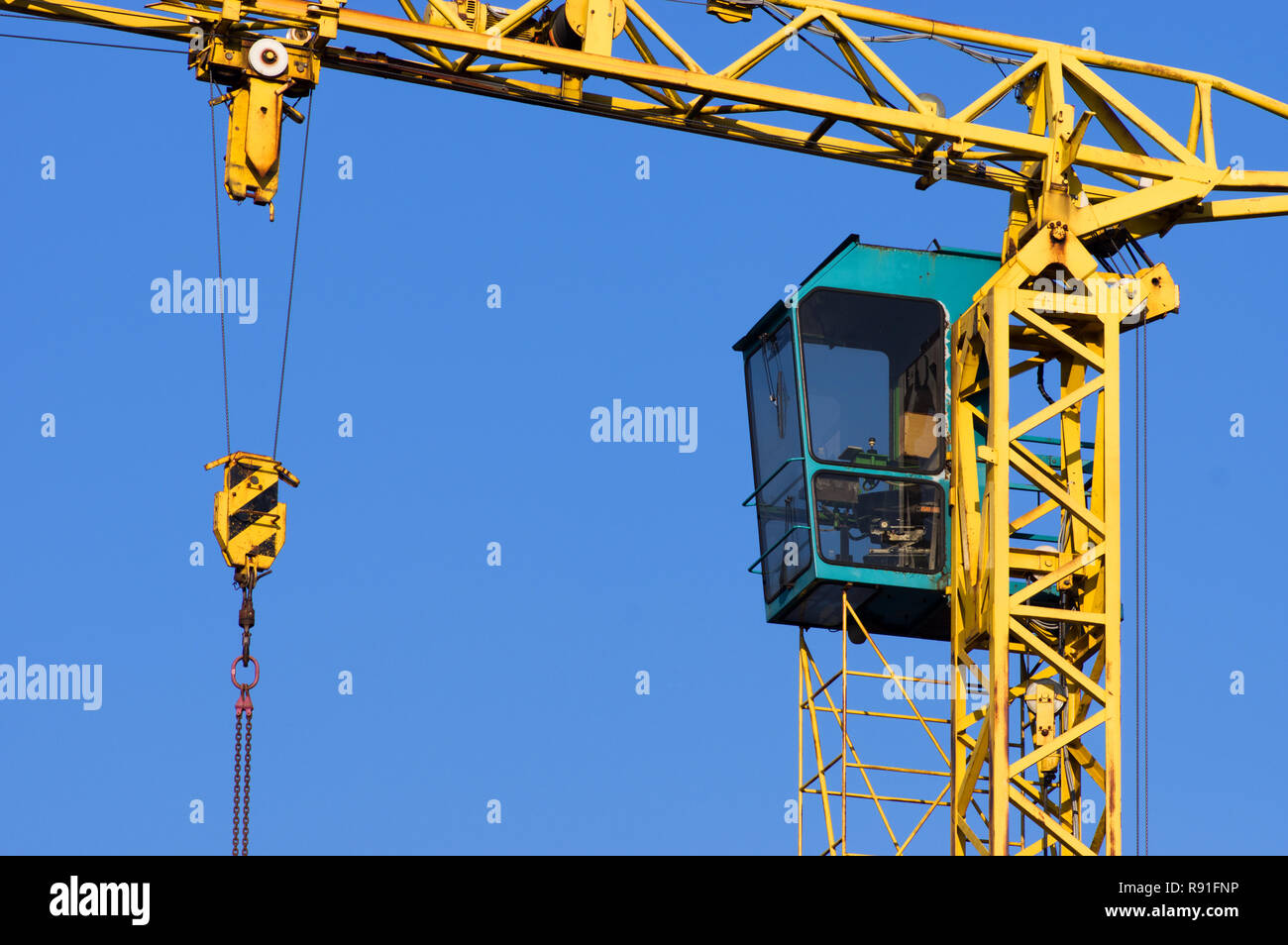 Close-up of a yellow tower crane cabin Stock Photo - Alamy