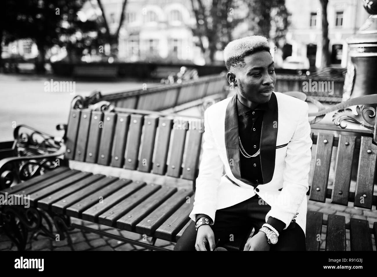 Chic handsome african american man in white suit sitting on bench Stock ...