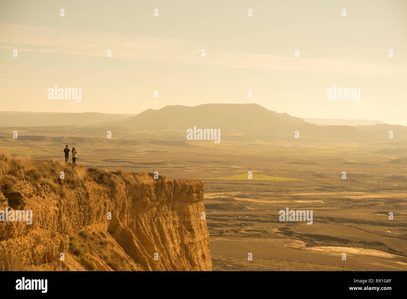 Couple looking the horizon at sunset in Bardenas Reales desert, Navarra (Spain) Stock Photo