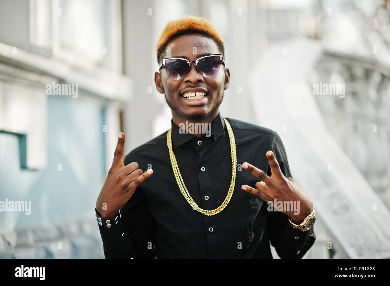 global Quagmire Appropriate Chic handsome african american man in black shirt with gold chain and  sunglasses Stock Photo - Alamy