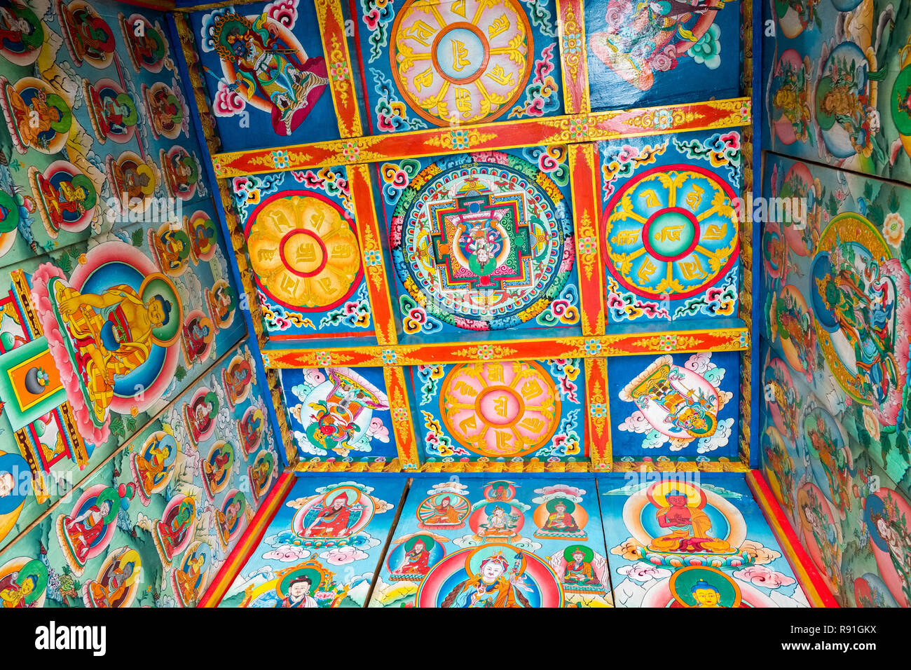 Highly decorative paintings of mandalas inside a Tibetan Kani (village entrance arch ), Nepal Stock Photo