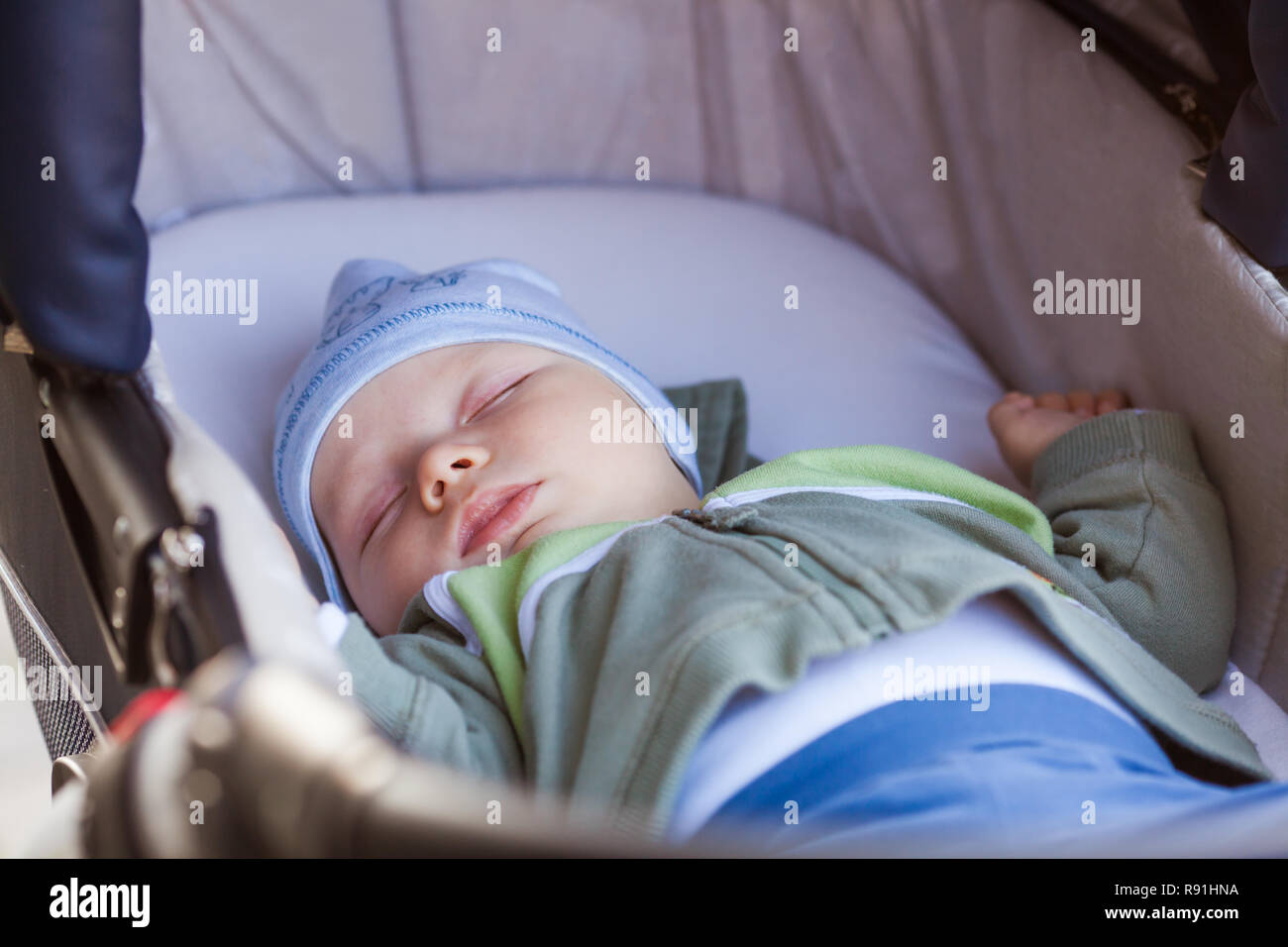 Baby sleeps in pram while family walk Stock Photo Alamy