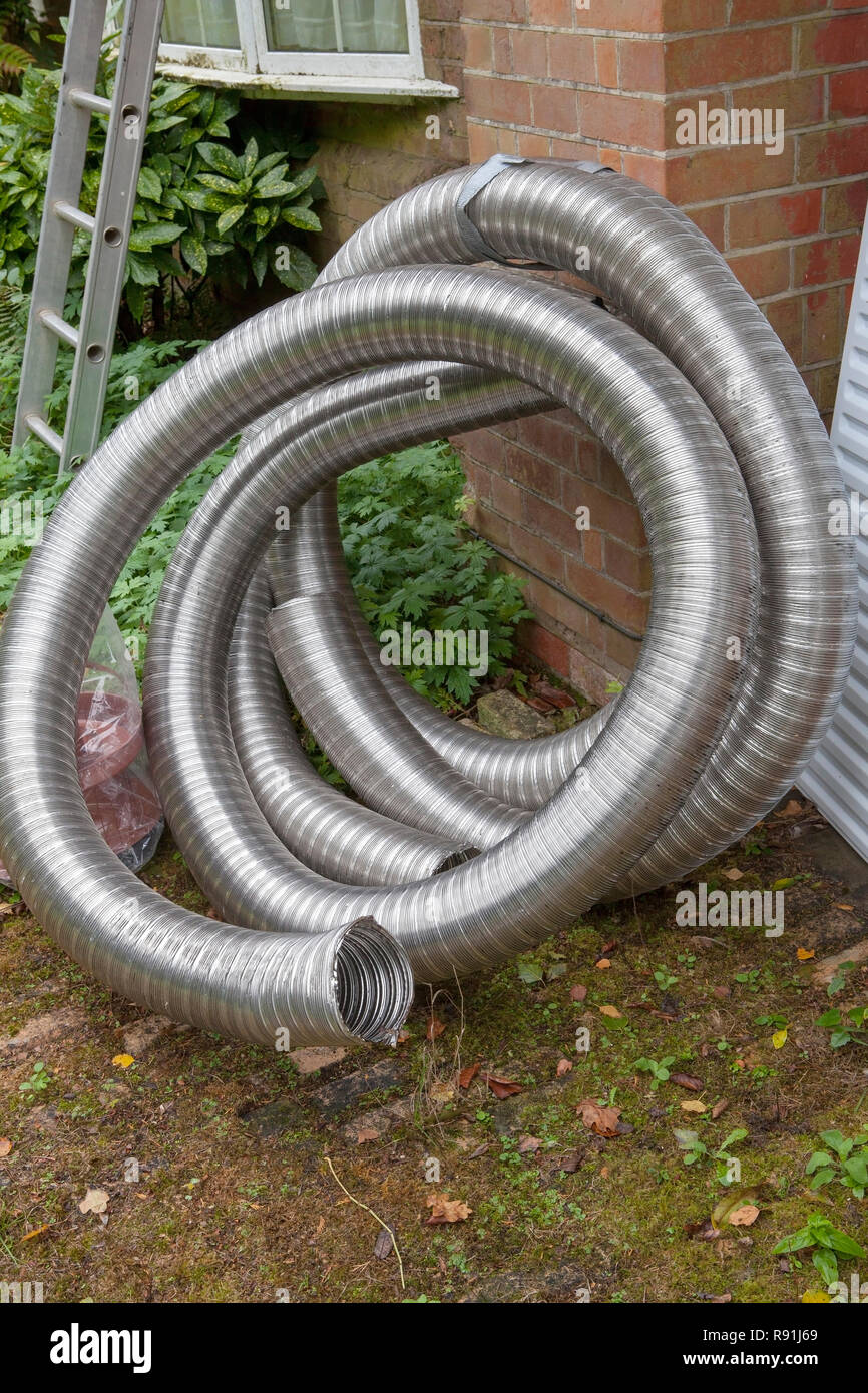 Roll of chimney liner waiting to be installed for a wood burning stove
