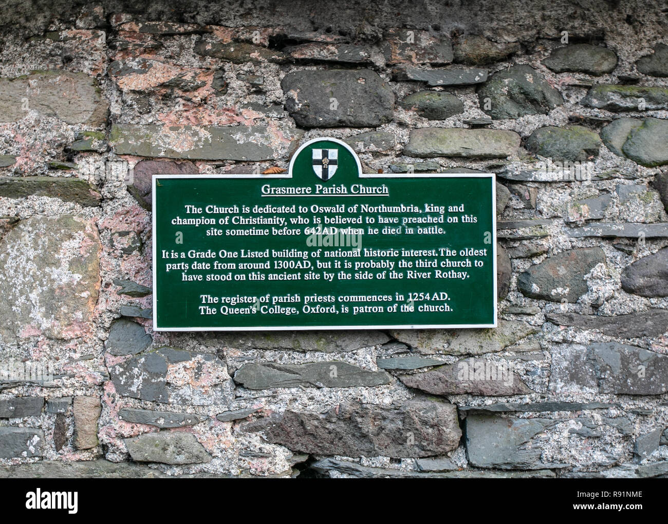 Plaque on the wall next to the entrance of the Grasmere Parish Church explaining the history of the church Stock Photo