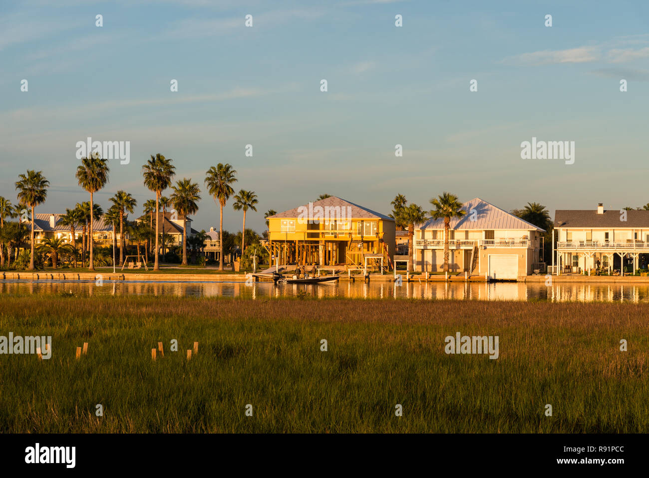 Residential houses encroaching venerable wetlands in upper Gulf coast.   Aransas National Wildlife Refuge, Texas, USA. Stock Photo
