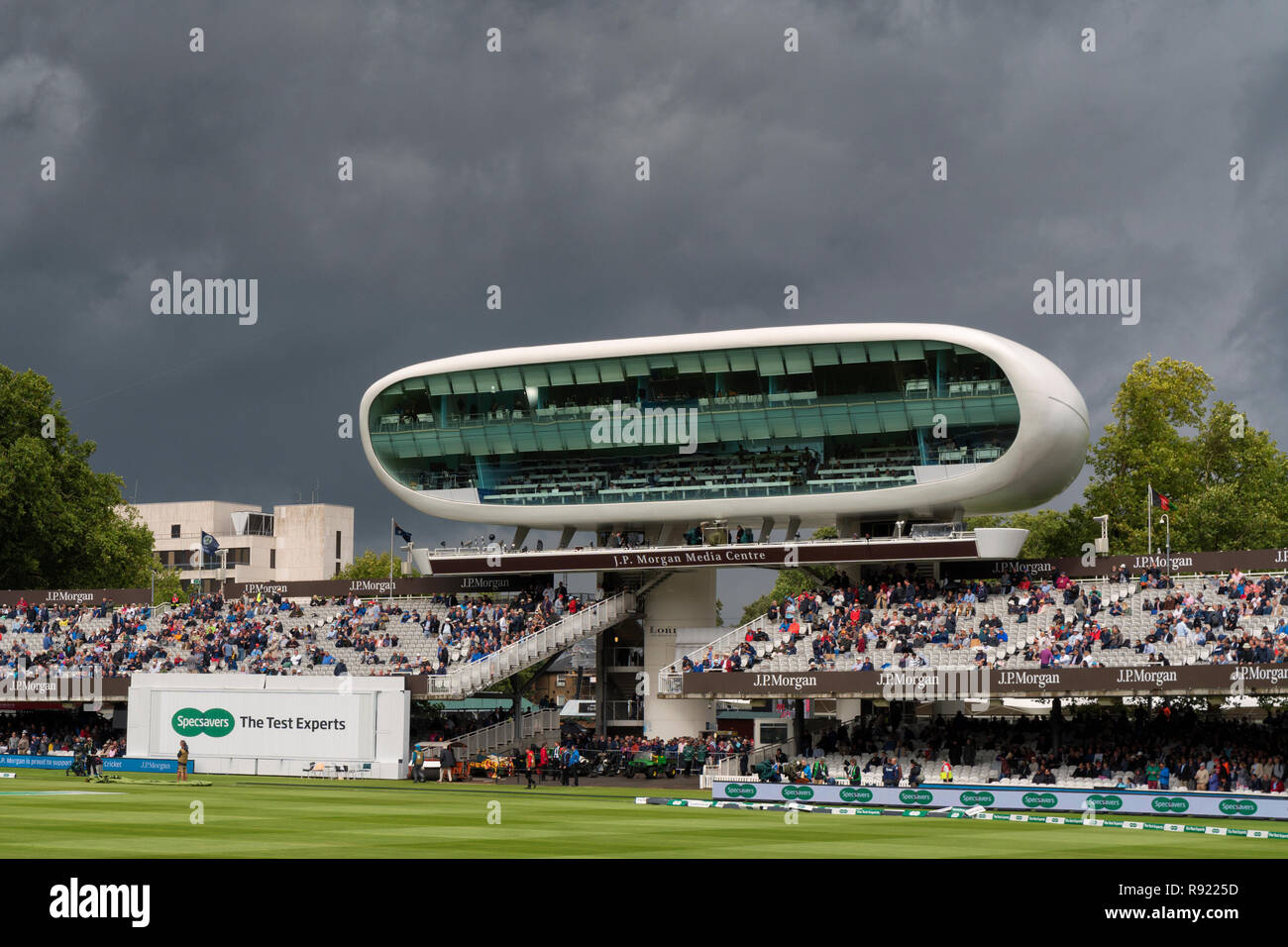 The J P Morgan Media Centre standing out against a dark stormy sky during the England v India 2018 test match at Lords. Stock Photo