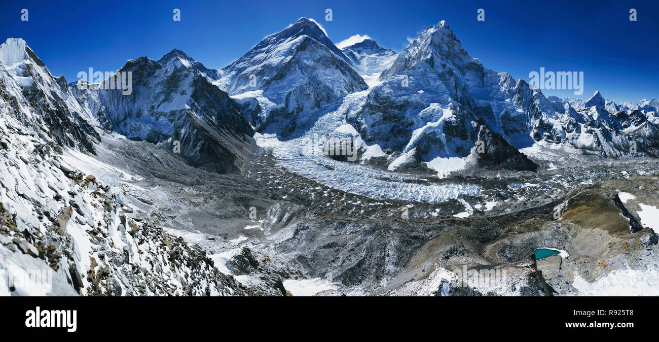 Panorama of Mount Everest and surrounding peaks taken from Camp 1 on Pumori, Nepal. From left to right the prominent peaks and features are: Lingtren, Khumbutse, Changtse, Everest, Everest West Shoulder (foreground), Lhotse, Nuptse, and Ama Dablam. Stock Photo