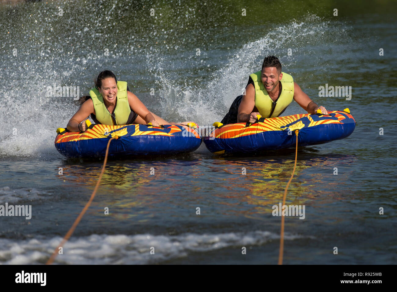 Young man and woman tubing together on Fox River in summer, De Pere