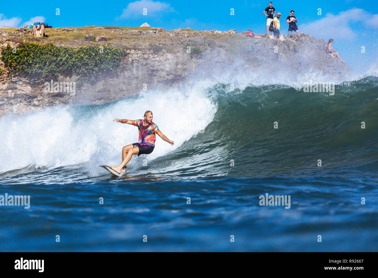 View of young male surfer riding wave in sea, Jimbaran, Bali, Indonesia Stock Photo