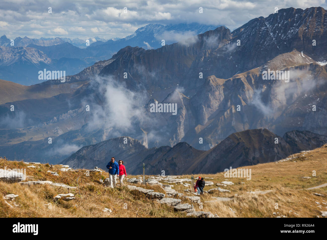 Scenic landscape with hikers on Rosenbaden, broad ridge below Chaserrug mountain in Canton of St. Gallen, Switzerland Stock Photo