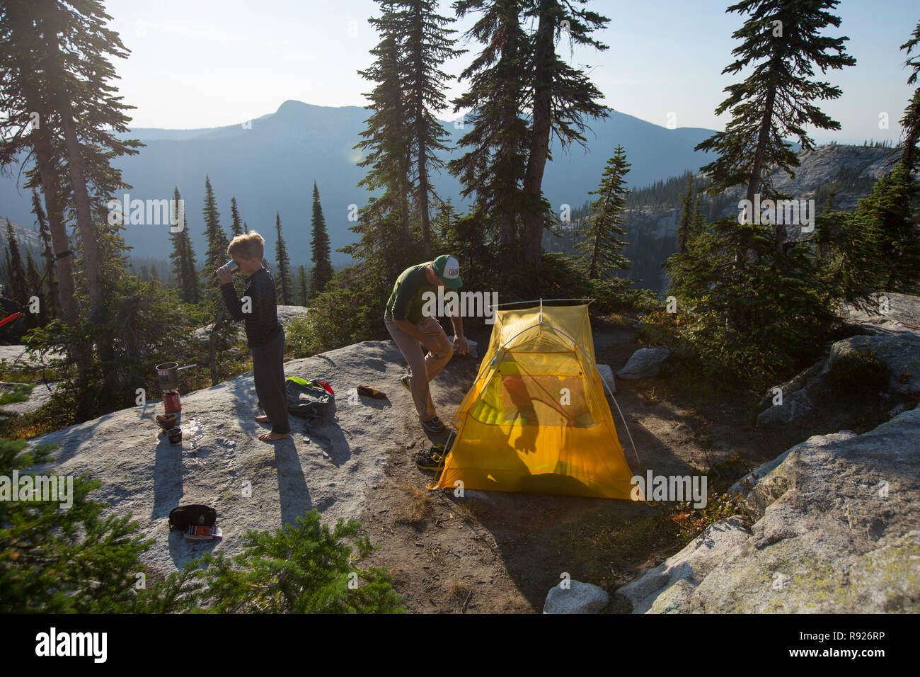 View of a father and son near a camping tent in the mountains, Selkirk Mountains, Sandpoint, Idaho, USA Stock Photo